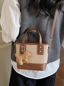 Chic vintage style two-tone canvas and leather bucket bag with cute dog charm