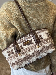 Vintage plush tote bag with brown pattern and leather straps shown on model shoulder