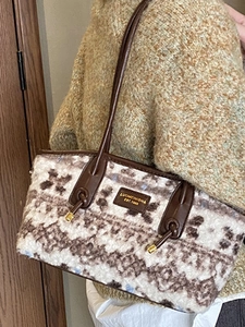 Fuzzy faux fur tote bag with brown leather straps and vintage leopard texture pattern