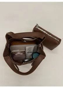 Deep brown pebble leather bucket bag showing large internal capacity for daily essentials