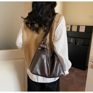 Deep brown matte tote bag shown from behind to highlight large capacity and daily style