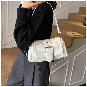 Chic white leather shoulder bag with large metal buckle shown on a model's shoulder