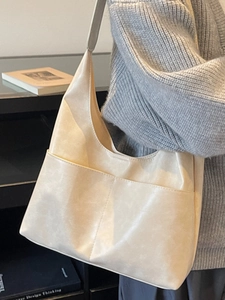 Large beige suede tote bag with wide shoulder strap and front pockets for women