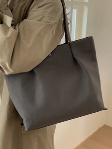 Minimalist large capacity charcoal canvas tote bag with brown leather straps and metal buckle