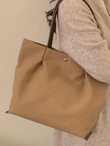 Minimalist large khaki tote bag with brown leather straps and silver metal studs for women