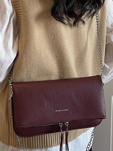 Burgundy pebbled leather crossbody bag with silver chain strap and front logo print
