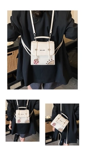 Close-up of white PU leather mini backpack with ladybug pattern and adjustable straps