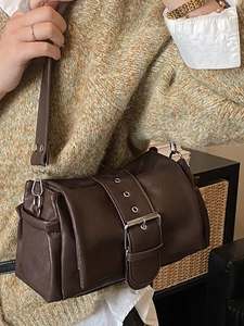 Deep brown leather baguette bag with wide buckle strap and silver hardware accents