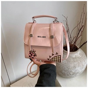 Detailed view of pink PU leather backpack with HELAHE logo and ladybug embroidery