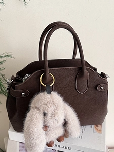 Dark brown leather shell bag with lychee texture and cute plush rabbit pendant charm