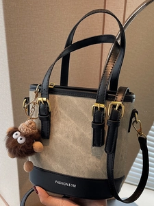 Fashion canvas and leather bucket bag with plush charm and detachable strap