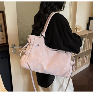 Pink tote bag detail with vintage stone texture and adjustable side drawstring design