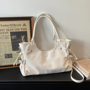 Detail of off-white tote bag with side drawstring pleats and versatile shoulder straps