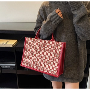 Détail du sac cabas de mariage rouge avec motif traditionnel et anses en cuir