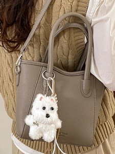 Chic grey litchi grain bucket bag with wavy edge and cute plush dog charm
