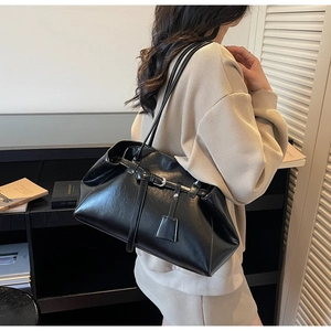 Minimalist black PU leather tote bag with buckle detail shown on a female model