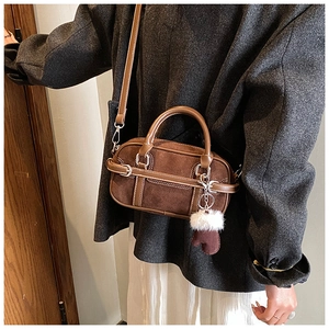 Brown suede baguette bag with leather strap and plush glove charm detail for winter