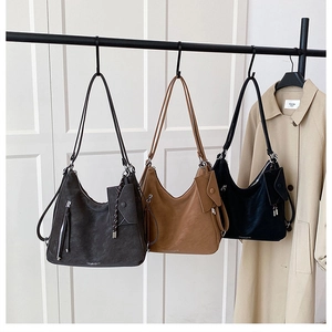 Detail of large tote bags in black, brown and grey with pebbled leather and mini pouches