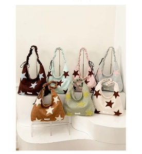 Multiple colors of corduroy shoulder bags with plush star patches and ruched handles