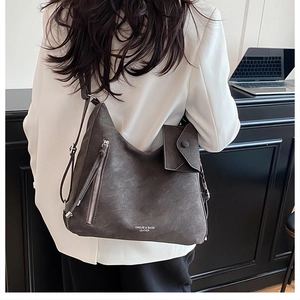 Detailed view of deep brown large hobo tote bag with sub-bag on model for daily commute