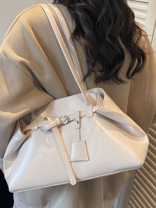 Chic cream white high-gloss shoulder tote bag with decorative buckle and charm detail