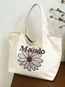 Sac fourre-tout minimaliste en toile blanche avec marguerite brodée et bandoulières chic