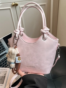 Pink marbled leather bucket bag with top handle, teddy bear charm, and MIAOSHE BAGS logo