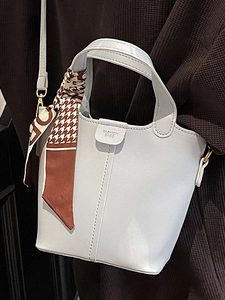 Light blue bucket handbag in matte leather with decorative scarf and shoulder strap