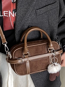 Brown suede Boston bag with double handles and heart charm accessory for women