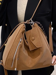 Brown high-capacity tote bag in soft matte leather with a side flip-cover charm