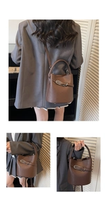 Close-up of brown pebbled leather bucket bag featuring silver metal buckle and top handle