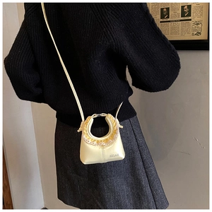 Detail of light yellow bag with lace ruffle round handle shown in a lifestyle scene