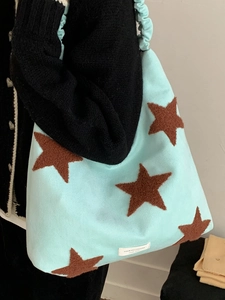 Light blue tote bag with brown plush stars and ruched shoulder strap for women