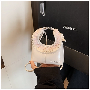 Detailed close-up of a white mini cloud bag featuring pink lace trim and brand logo
