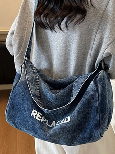 Retro blue washed denim crossbody tote with REPLACED lettering and wide shoulder strap
