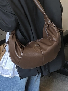 Brown vintage half-moon hobo bag with pleated texture and wide shoulder strap