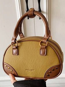 Retro olive green bowling handbag with brown handles and litchi grain leather texture