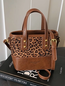 Vintage leopard print and brown leather crossbody bag with adjustable gold buckles