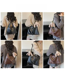 Detailed view of the vintage PU leather tote bag with metal chain and plush rabbit charm