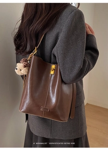 Deep brown faux leather tote bag with gold buckle and leopard print bear charm