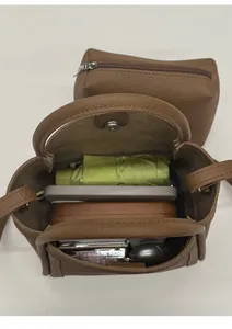 Vertical top view showing spacious interior of the brown bucket bag with everyday essentials