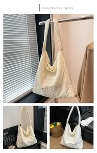Detail of quilted puffer tote bag with Never Say Goodbye 3D embroidery and wide strap