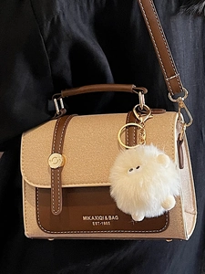 Retro contrast color crossbody bag in beige and brown with golden buckles and plush charm