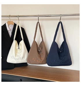 Detailed embroidery showing Never Say Goodbye text on quilted cotton hobo tote bags