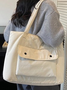Quilted beige puffer tote bag with large front pocket and wide shoulder strap