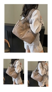 Close-up of brown vintage leather tote bag showing double front zipper pockets and texture