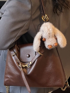 Vintage dark brown leather tote bag with a cute beige plush bunny keychain for women