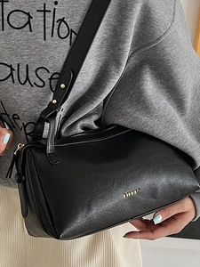 French style black pebbled leather baguette bag with gold logo and adjustable strap