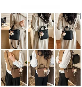 Fashionable bucket bag for women showing crossbody strap and cute bear charm detail