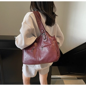 Detailed view of the vintage wine red leather tote bag showing texture and side pockets